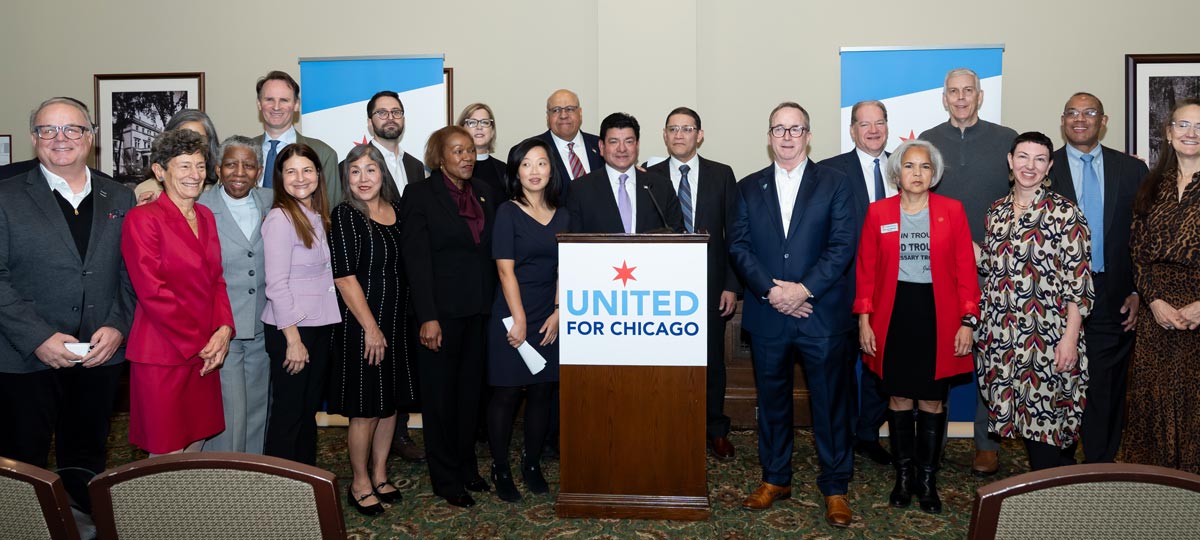A group of people posing for a photo with a podium that says 